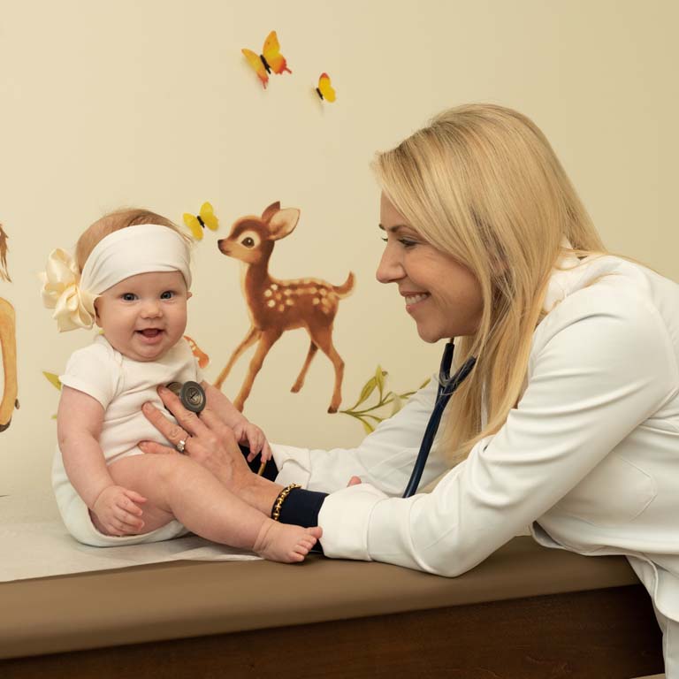Dr. Jill examines a happy baby at Brentwood Pediatric Care.